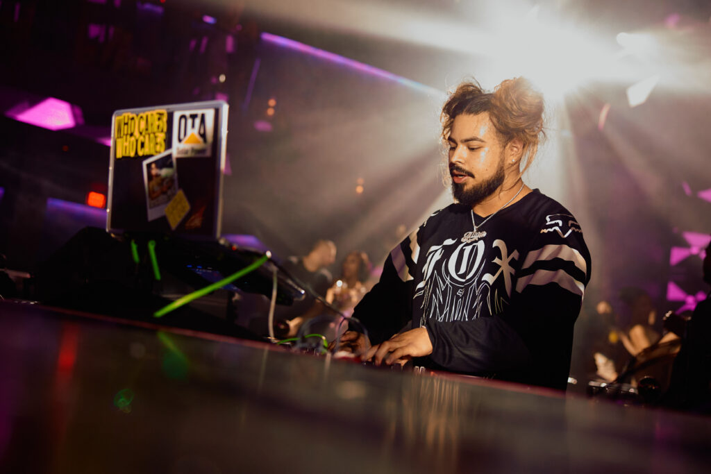 DJ AR playing music behind the DJ Booth.