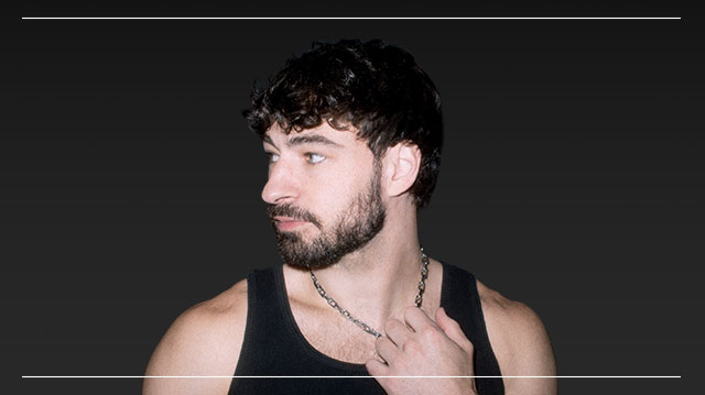 Crankdat looking to the side and holding onto his necklace.