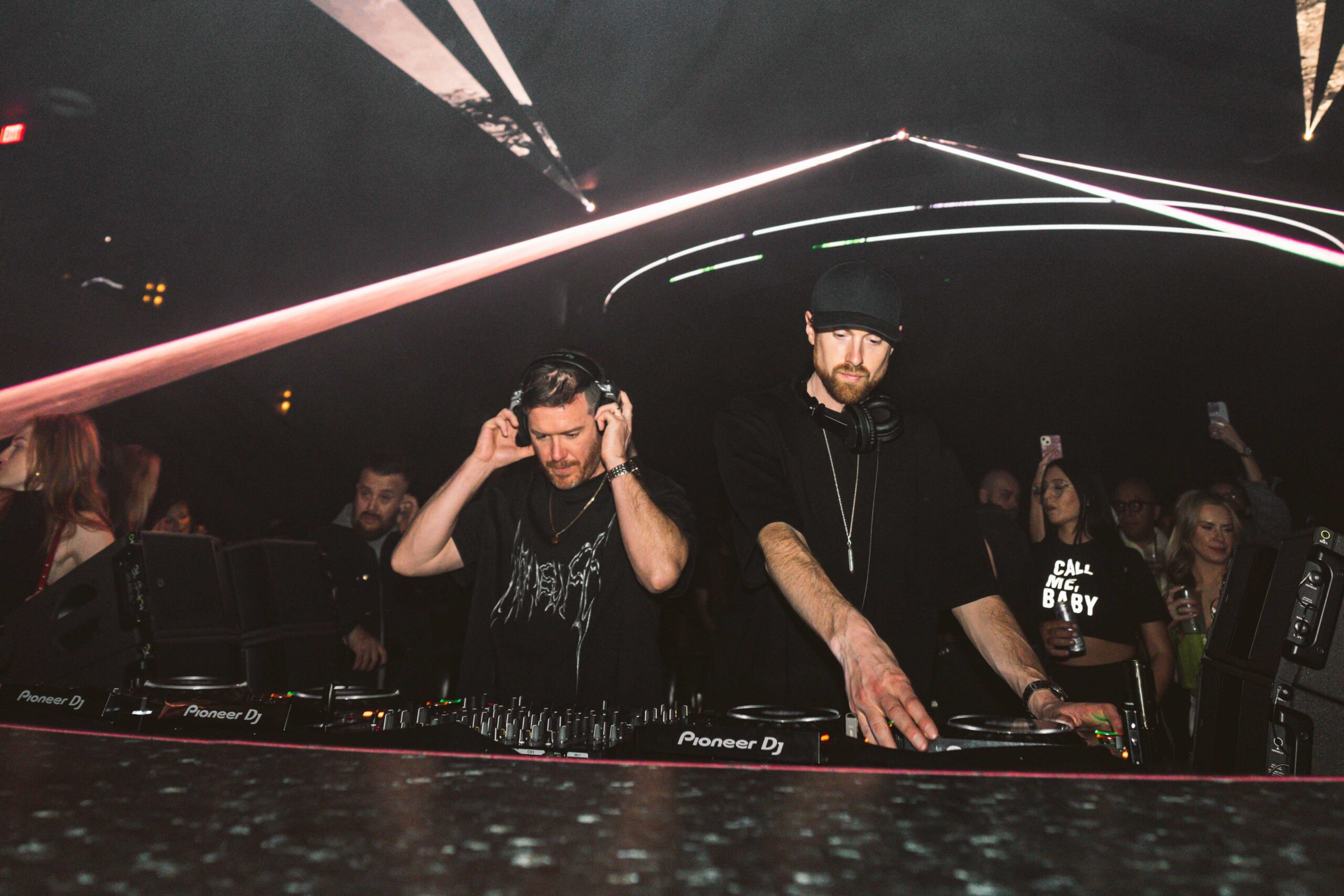 Gorgon City DJing at LIV Las Vegas with crowd and dramatic laser lighting effects.