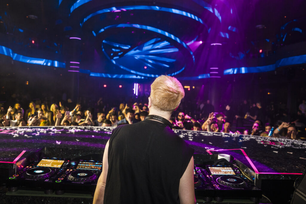 Layton Giordani DJing at LIV Las Vegas with crowd and vibrant club lighting.