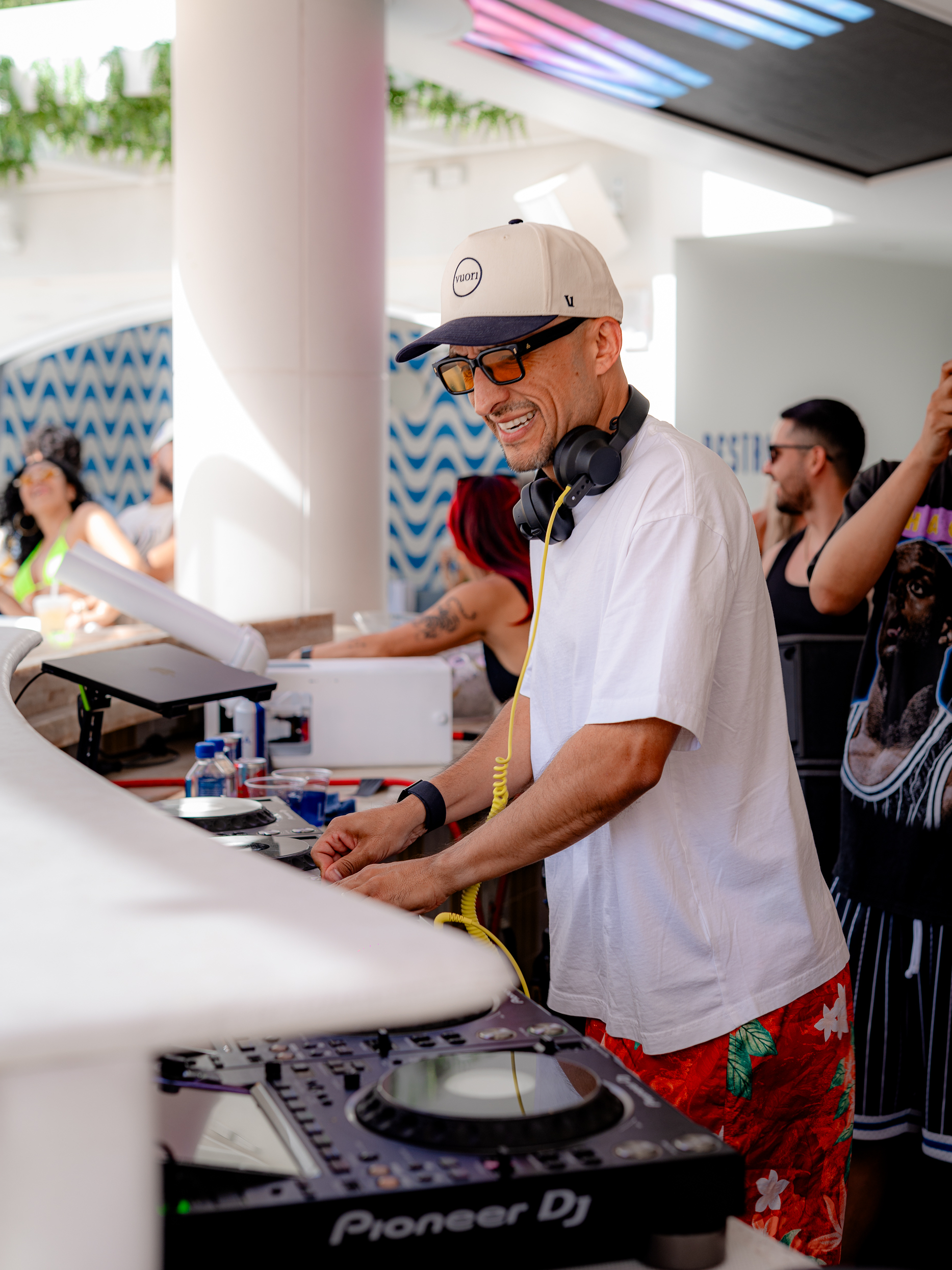 DJ Vice performing a daytime set at LIV Beach, with crowd energy building behind the booth.