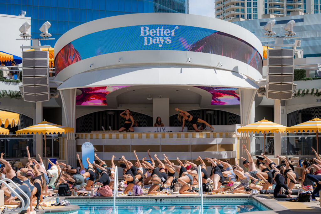 Crowd participating in synchronized workout session poolside during Sunday Circuit at LIV Beach.
