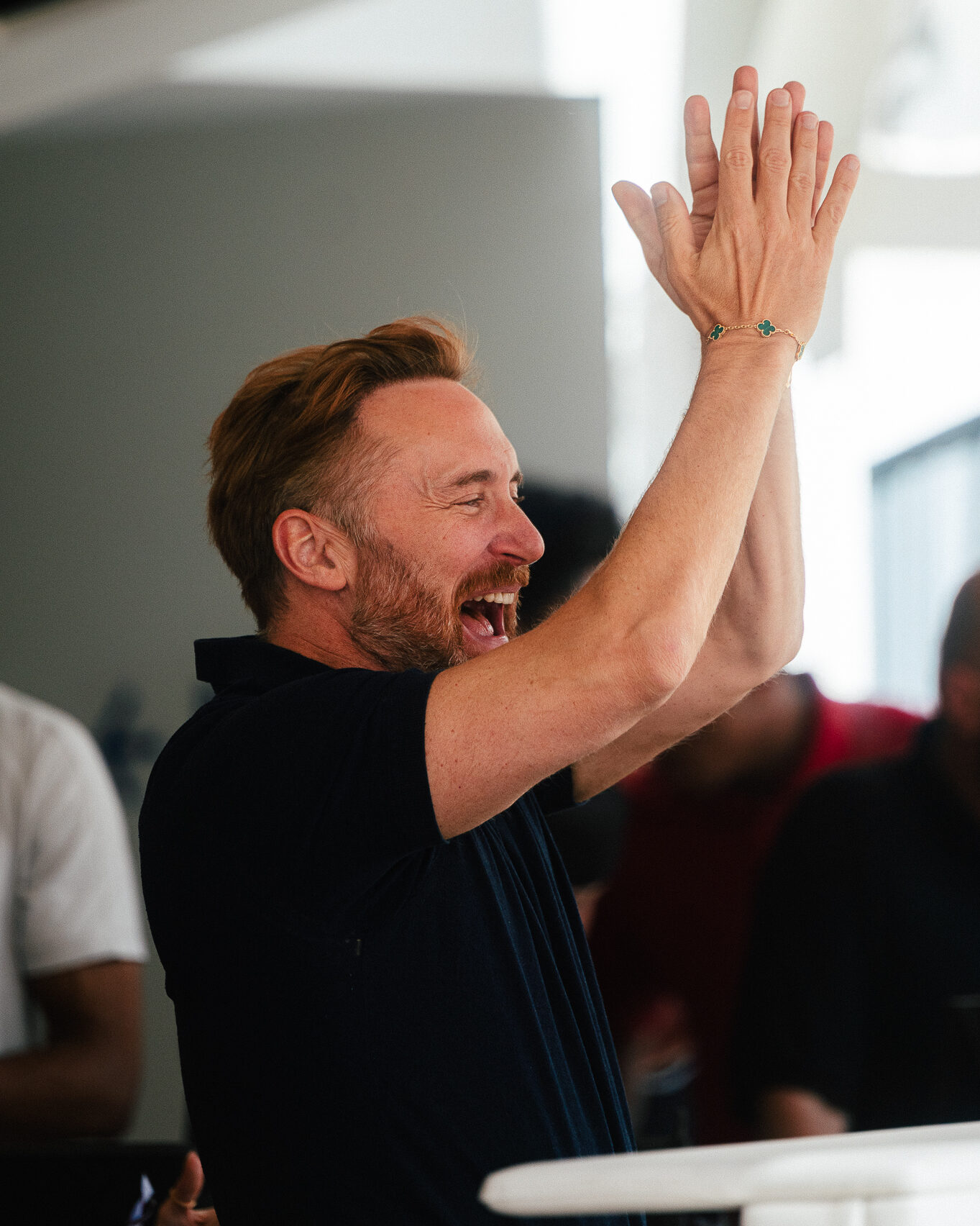 David Guetta celebrating with the crowd behind the DJ booth at LIV Beach.