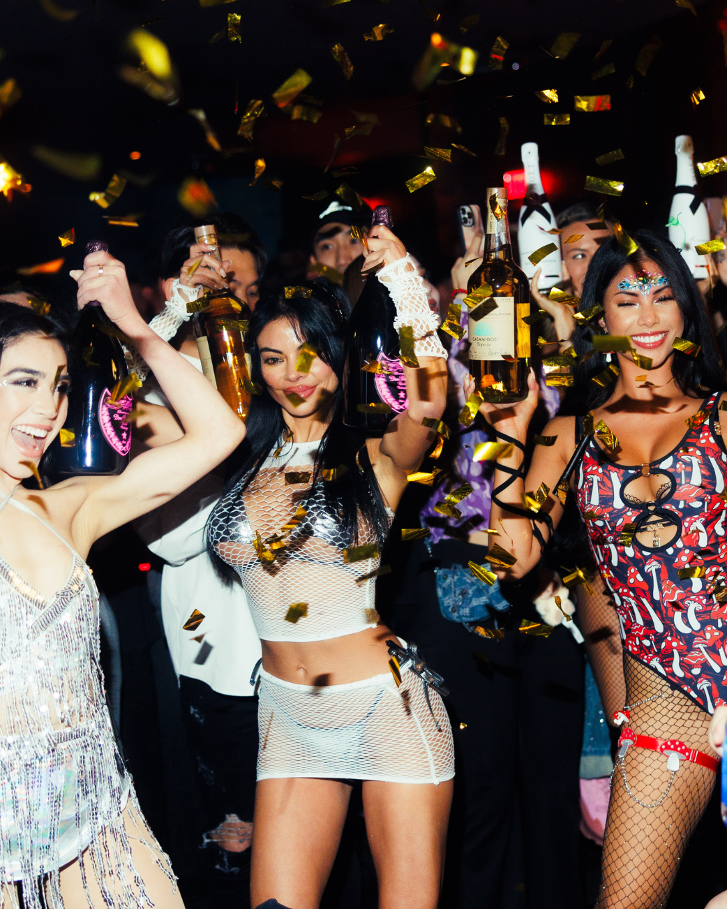 Bottle presentation with champagne under falling gold confetti at LIV Nightclub.